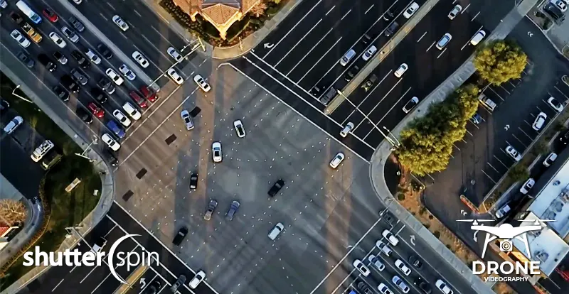 Bird’s-eye drone view of a busy neighborhood intersection, captured by ShutterSpin. Aerial imagery highlights accessibility, nearby roads, and community flow to help buyers understand the neighborhood before purchasing a home.